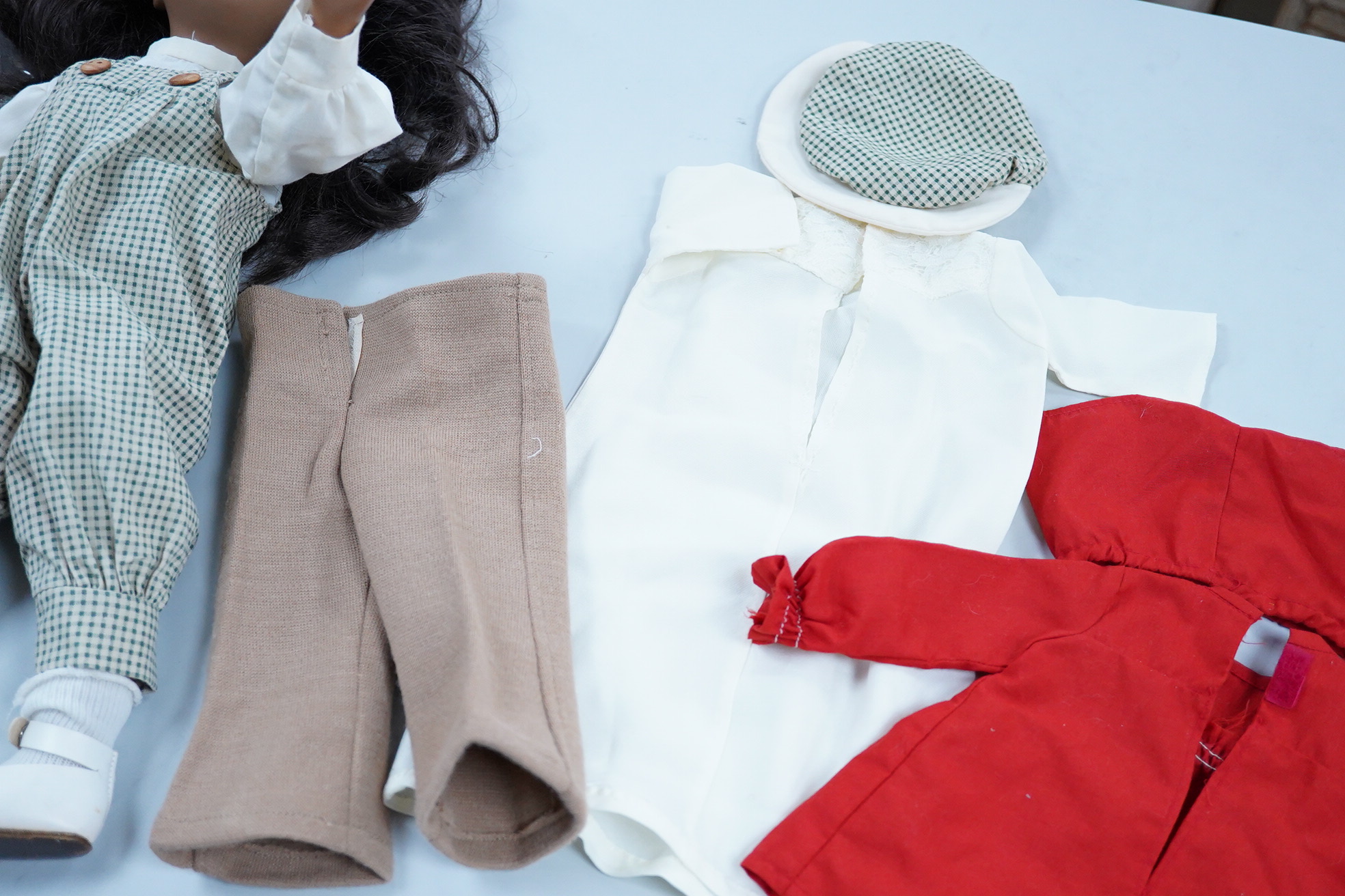 A Sasha Doll, 42cm high, with a selection of clothes, including some possible original commercially produced clothes together with other handmade clothes